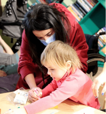 Creative interaction: a girl and a child drawing together